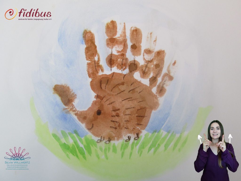 Gemaltes Bild eines Igels in Form eines Handabdrucks. Gebärde: Beide Hände zeigen eine Bewegung mit jeweils einem Finger nach oben.